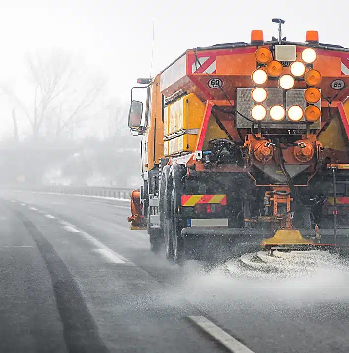 Snow-covered road treated with anti-icing and de-icing products