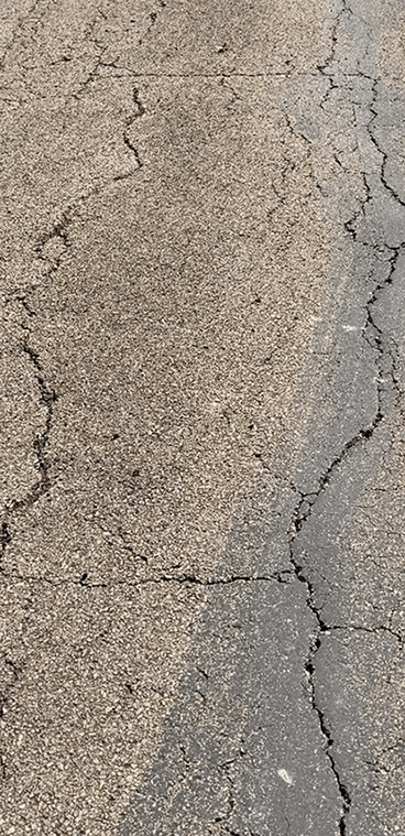 Faded gray asphalt surface before EnviroBlack application